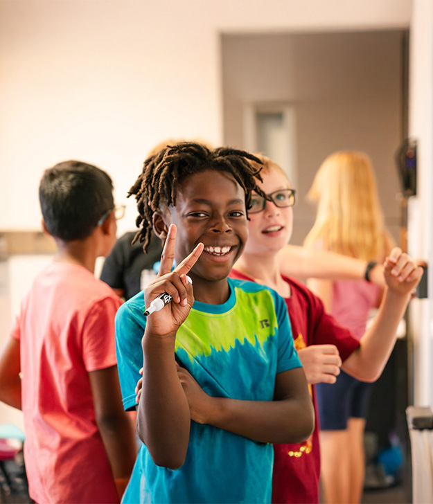 Kids_Programming_07.14.24_LR_-93boy,_elementary,_kids,_RR,_smiling,_Sunday_morning,_Woodmen_Valley_vertical.jpg